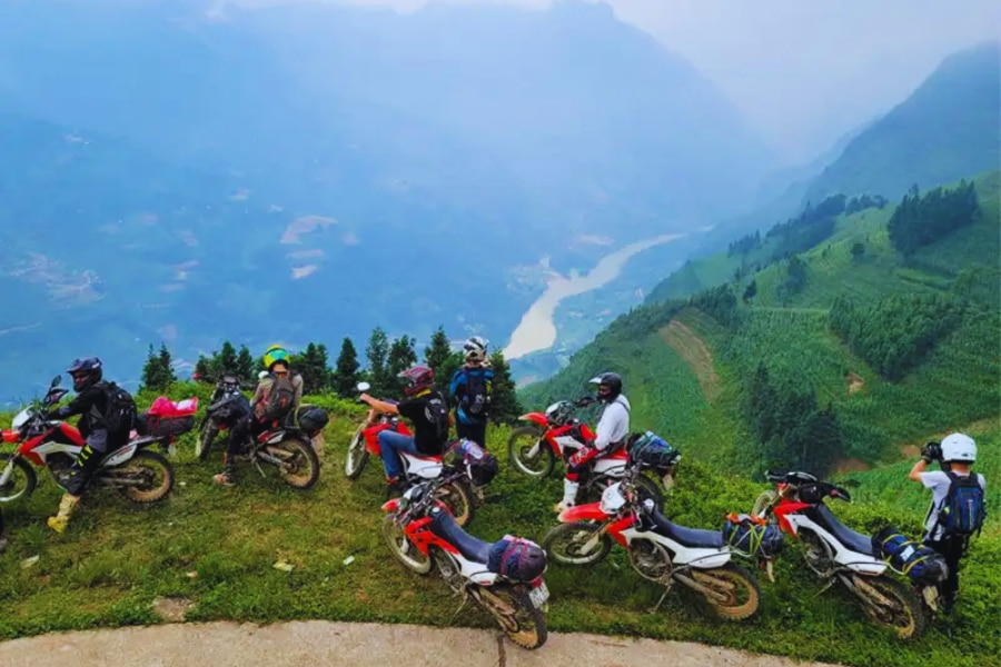 Motorbike riders exploring Ha Giang mountains on a scenic Vietnam road trip